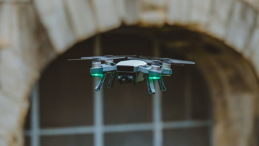 flying green and black quadcopter drone thumbnail
