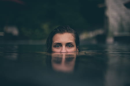 woman swimming on body of water thumbnail