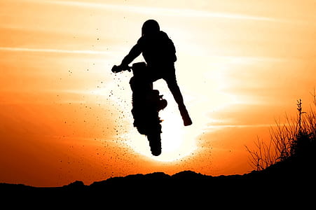 silhouette of a man making trick on his dirt motorcycle thumbnail