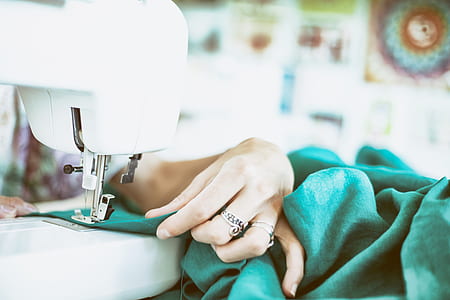 selective focus photography of person stitching thumbnail
