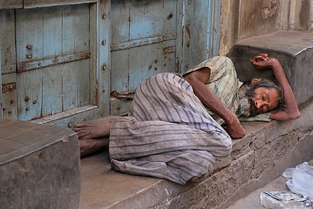 man sleeping beside closed door thumbnail