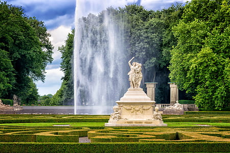 focused photo of character statue in maze garden thumbnail