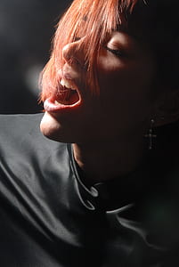 woman opening her mouth wearing black top thumbnail