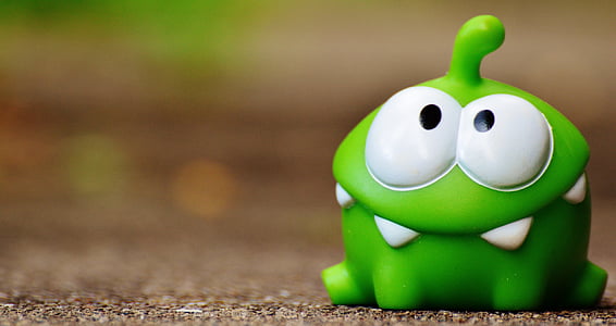 green cut the rope frog toy on brown surface thumbnail