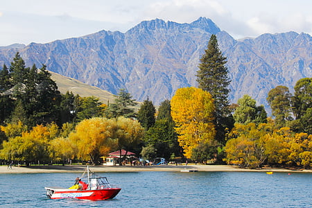 red boat on body of water during daytime thumbnail