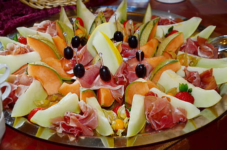 assorted sliced fruits and meat on silver platter thumbnail