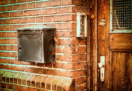 black mailbox mounted on brown brick wall thumbnail