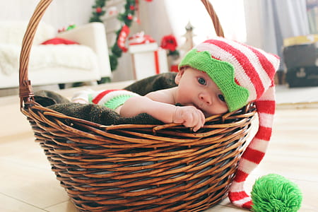 infant lying on brown basket thumbnail