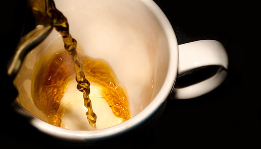 yellow liquid pour on white ceramic mug thumbnail
