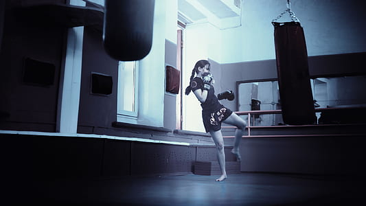 woman kicking black heavy bag thumbnail
