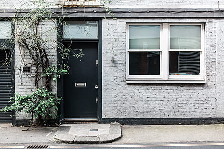 gray concrete house with black door thumbnail