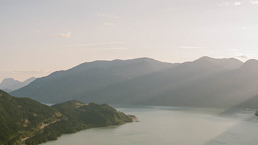 lake between green mountains at daytime thumbnail