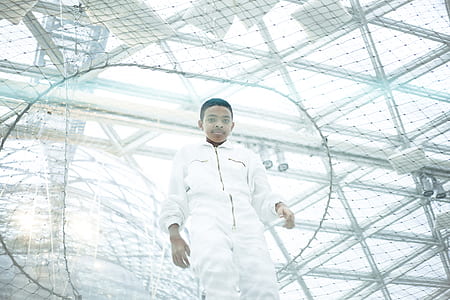 man wearing white overalls thumbnail