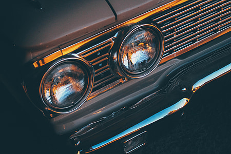 two round vehicle headlights in chrome grille thumbnail