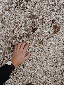 person left hand on brown surface thumbnail