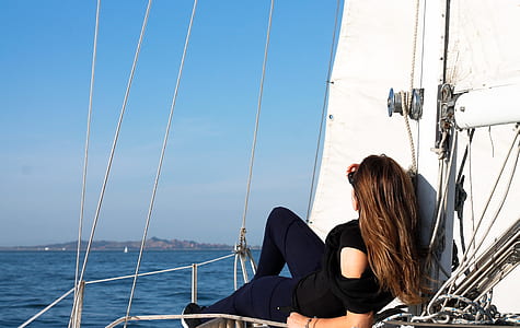 woman in black lying on sailboat during daytime thumbnail