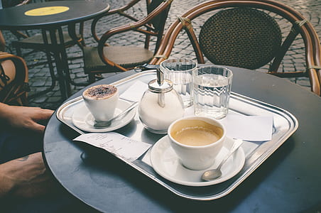 white ceramic teacup on gray steel tray thumbnail