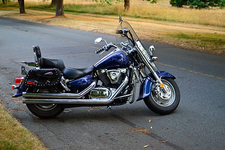 touring motorcycle parked on asphalt road near trees at daytime thumbnail
