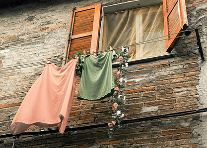 two pink and green shirt and skirts hanging on clothes line thumbnail