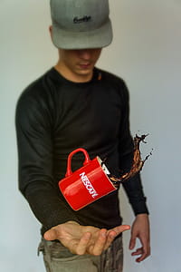 Photo Of Man Tossing Nescafe Mug thumbnail