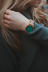 woman wearing brown analog watch with link bracelet and green sweatshirt thumbnail