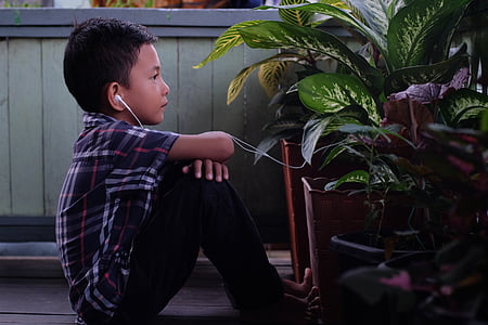 child sitting in front of plant thumbnail
