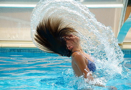 woman wearing blue bikini tops in swimming pool during daytime thumbnail
