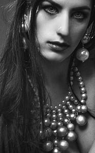 Grayscale Photo of Woman Wearing Beaded Necklace and Dangle Earrings thumbnail