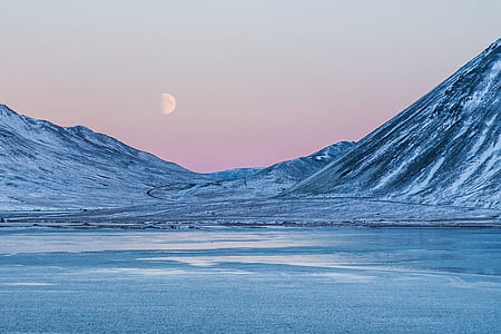 landscape photography of mountain covered snow near body of water thumbnail