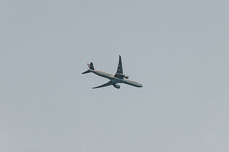 worm's-eye view photography of flying passenger plane thumbnail