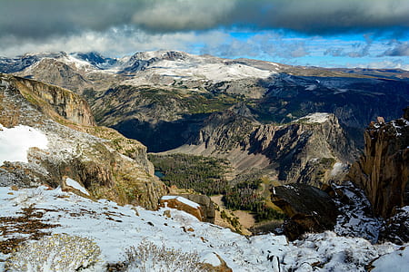 snow-covered mountain under cloudy blue sky thumbnail