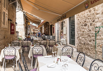 tables and chairs arranged outdoor with canopy on top thumbnail