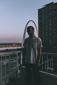 man standing on building's porch thumbnail