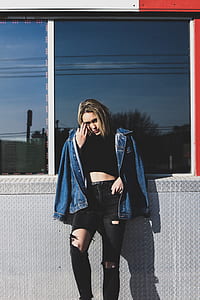 woman in blue denim jacket lean on wall thumbnail