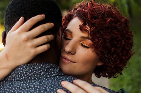 man and woman hugging each other during day time thumbnail