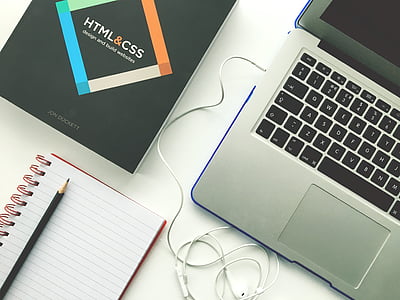 MacBook Pro beside spiral notebook thumbnail