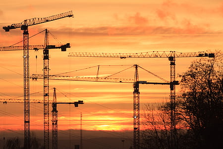construction cranes silhouette at golden hour thumbnail