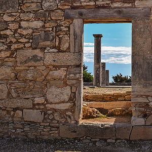 brown concrete pillar towers near green trees thumbnail