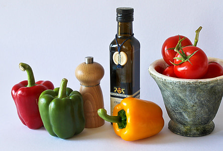 three capsicums with tomatoes, pepper mill and amber glass bottle thumbnail