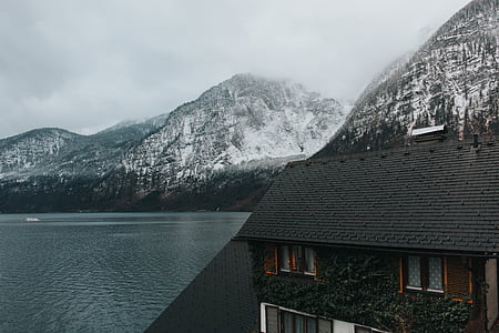 gray and brown house near body of water thumbnail
