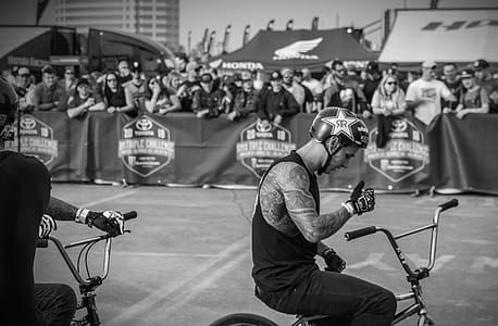 grayscale photo of man riding bike thumbnail