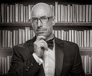 grayscale photo of man with hand on chin thumbnail