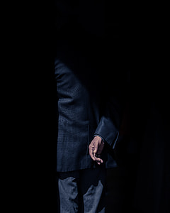 person wearing black suit jacket and black bottoms thumbnail