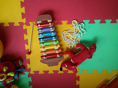 fox plush toy and multicolored glockenspiel toy on multicolored rubber mat thumbnail