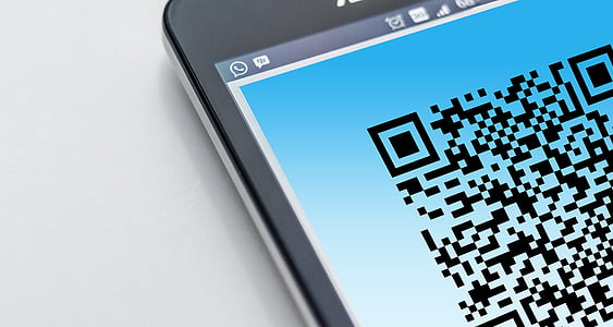 closeup photo of turned on smartphone displaying QR code thumbnail