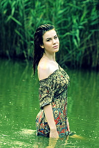 woman wears black and green floral top thumbnail