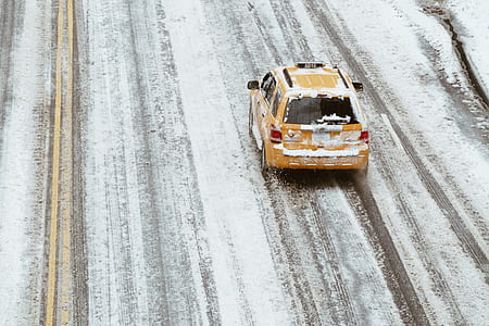 yellow taxi cab on snow filled asphalt road thumbnail