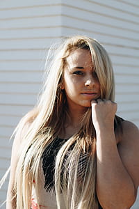 woman touching face with left fist thumbnail