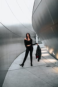 woman holding black jacket thumbnail