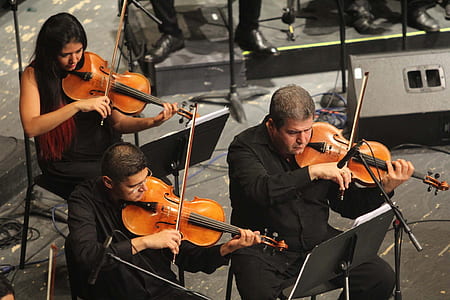 three person playing violins thumbnail